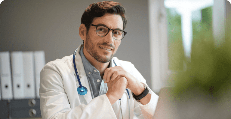 Doctor with stethoscope sitting at desk